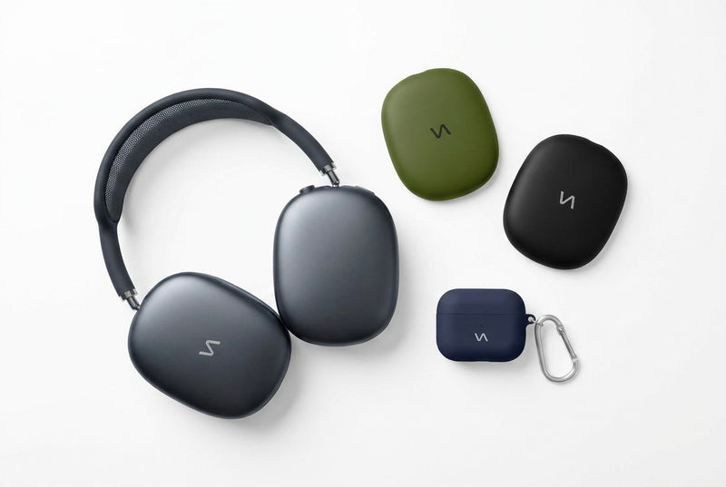 Graphite AirPods Max headphones with Olive Green and Onyx Black ear cup covers and a Midnight Blue silicone AirPods case with silver carabiner — VitaAurea AirPods Collection.
