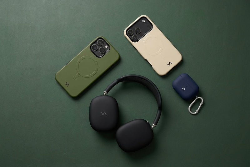 Olive Green and Ivory Silk slim MagSafe iPhone cases, Onyx Black AirPods Max headphones with matching ear cup covers, and Midnight Blue silicone AirPods case with carabiner — VitaAurea full collection.