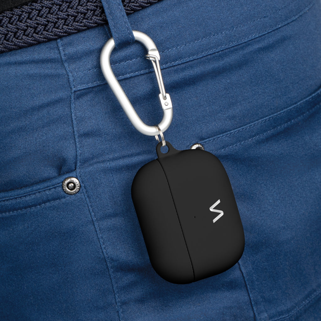 Black premium silicone AirPods case with minimalist logo and silver carabiner clipped to navy pants waistband.
