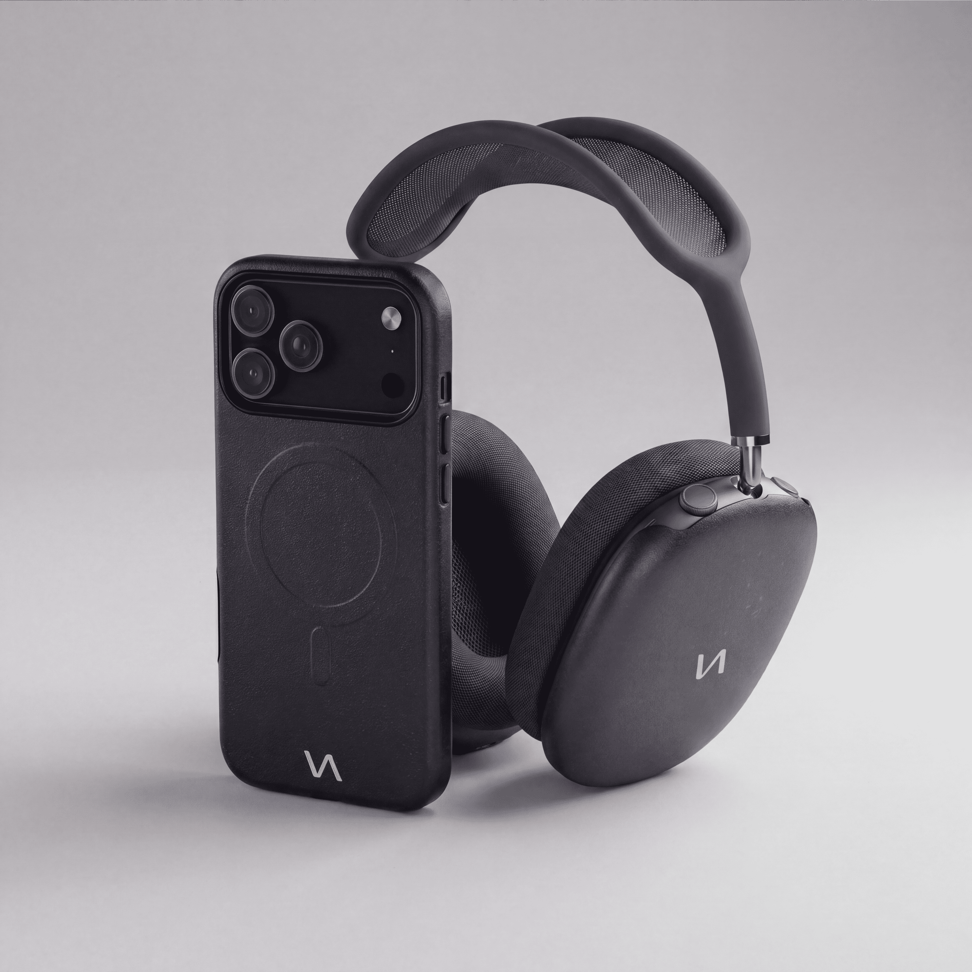 Graphite MagSafe iPhone case with slim profile paired with matching AirPods Max ear cup covers.
